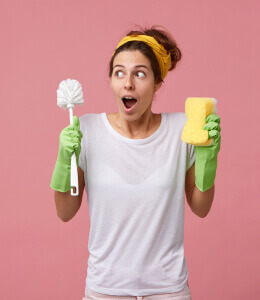 Woman holding cleaning supplies